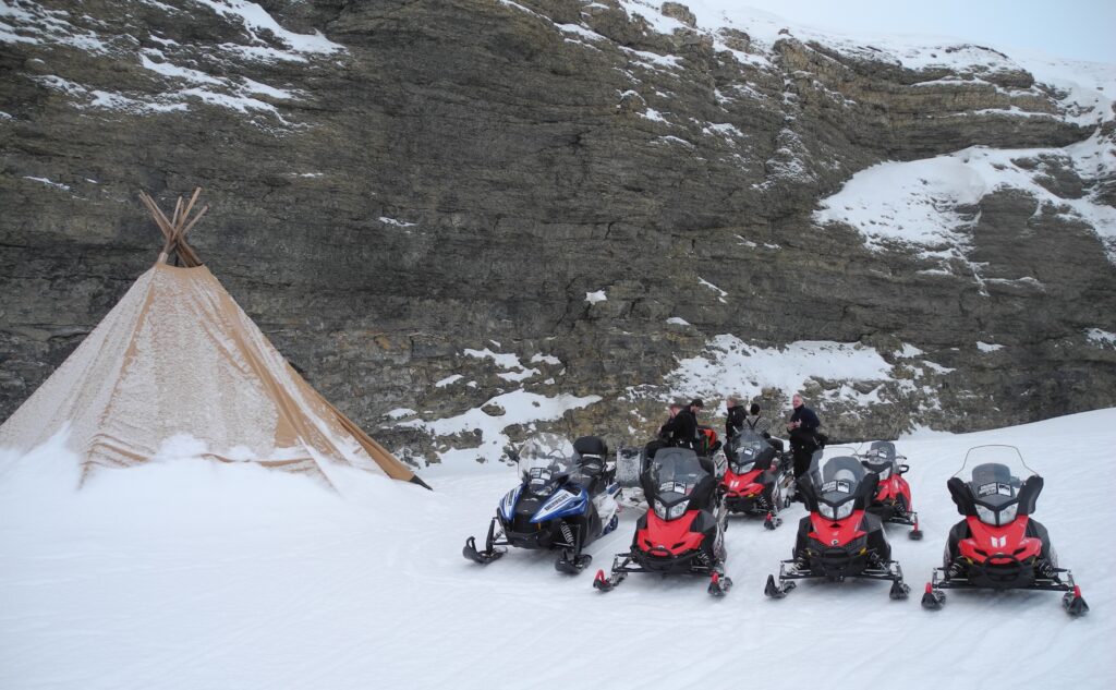 snowmobiles by the teepee